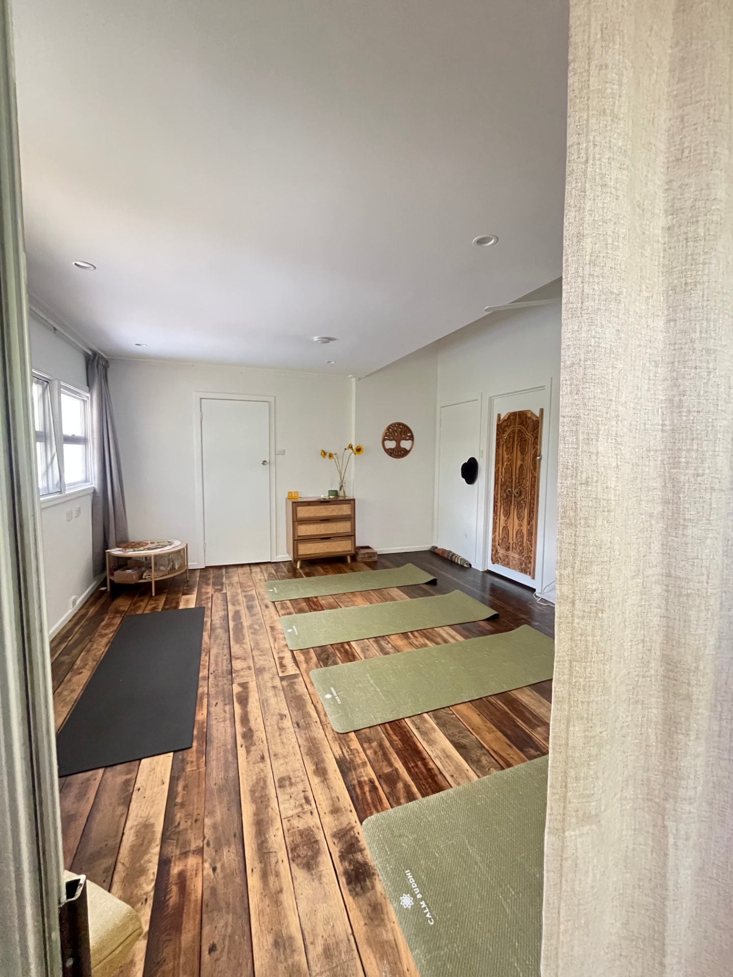 The INNER HOME studio space with timber floors and yoga mats