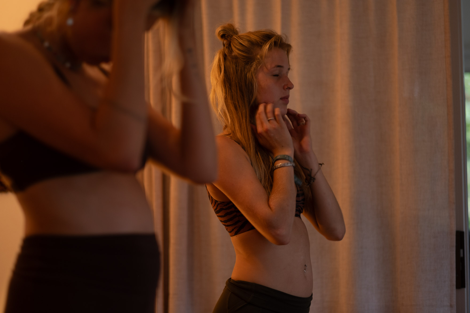 A student pausing in stillness by the window in golden evening light