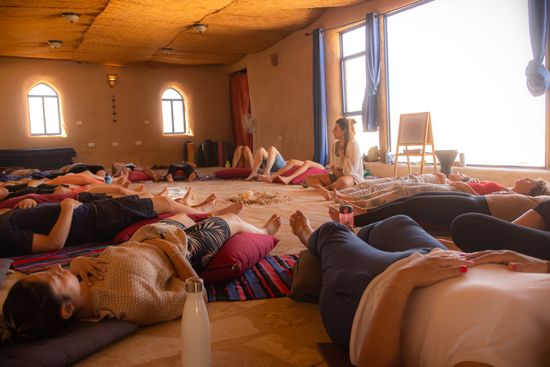 A group resting together in a warm earthen studio